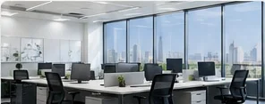 Open-plan office with rows of desks and floor-to-ceiling windows